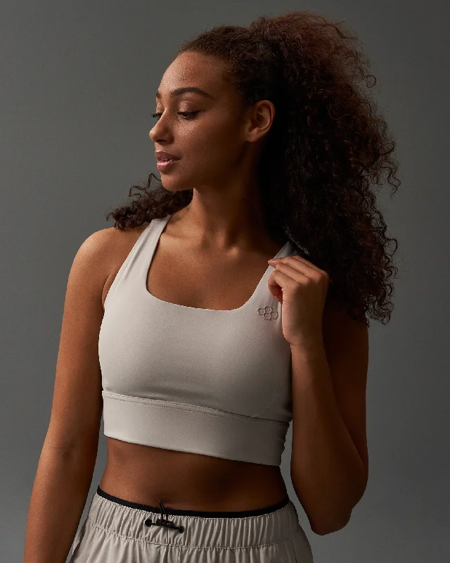 Sports bra with trendy straps -RUDIS Women's Medium Impact Padded Sports Bra - Bone